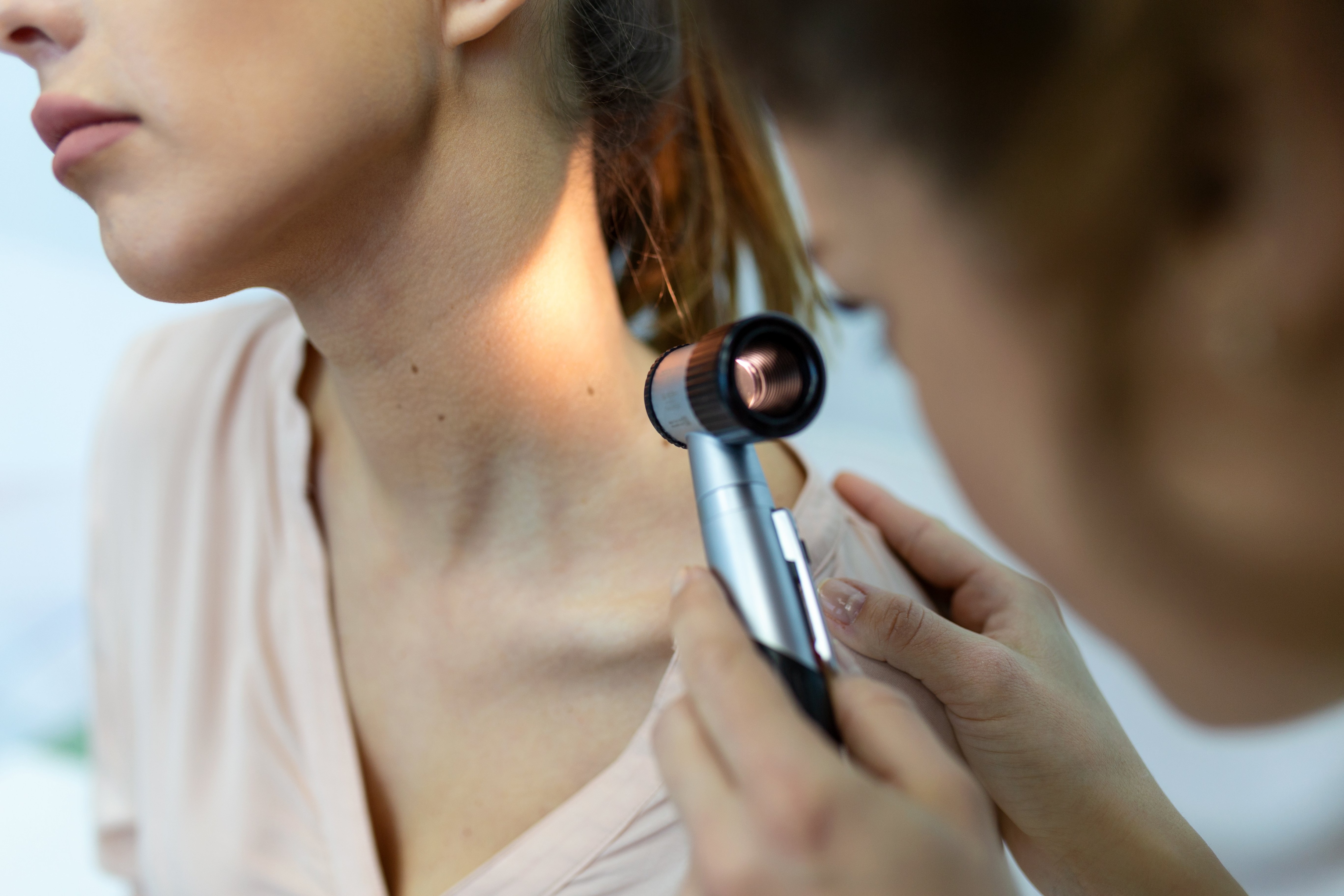 Dermatologist examining patient skin